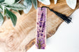 a bookmark with a purple flower design on it