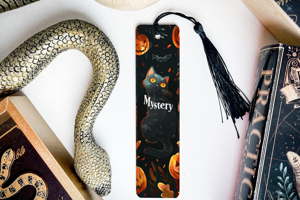 a bookmark with a cat on it next to a snake