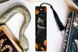 a bookmark with a cat on it next to a snake