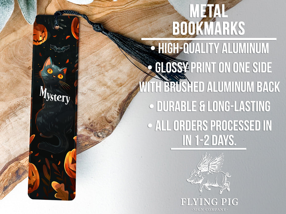 a bookmark with a black cat and pumpkins on it