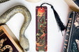 a bookmark with a dragon and a snake on it