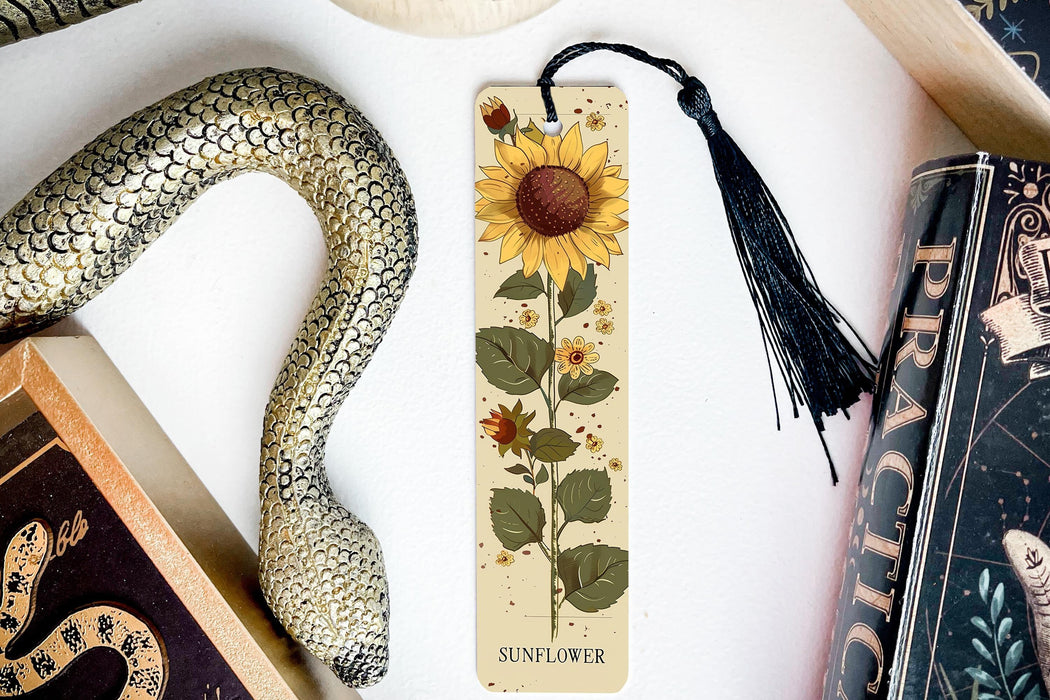 a bookmark with a sunflower on it next to other books