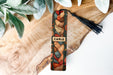 a close up of a piece of wood with a tassel