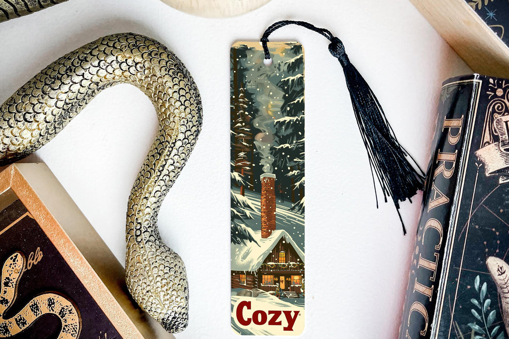 a bookmark with a picture of a snowy cabin and a snake