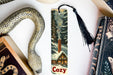 a bookmark with a picture of a snowy cabin and a snake