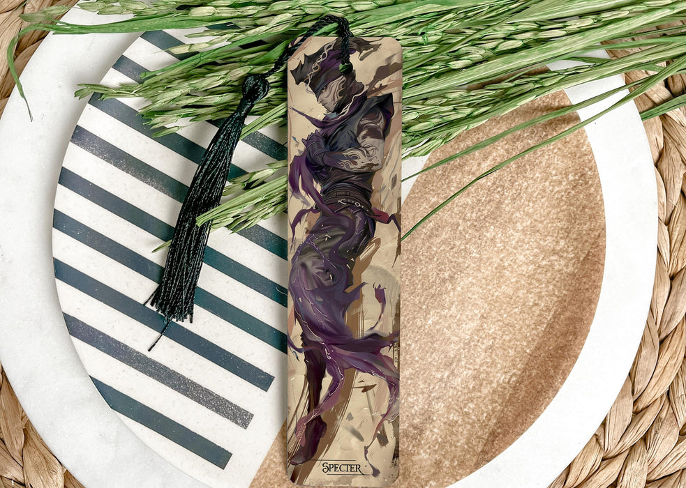 a white plate topped with a purple flower next to a green plant