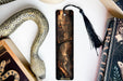 a bookmark with a picture of a woman and a snake on it