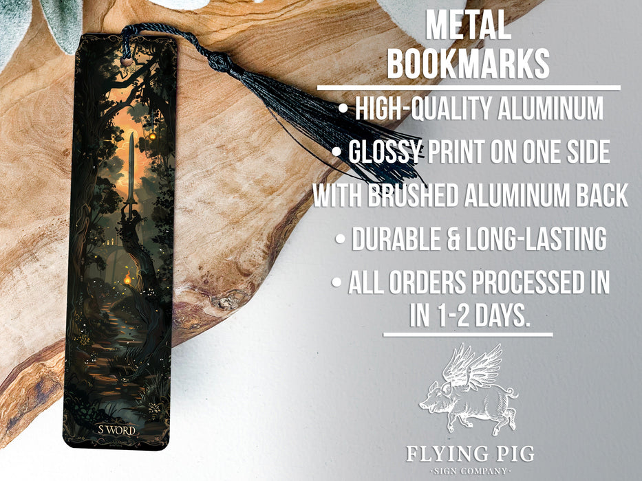 a metal bookmark with a forest scene on it
