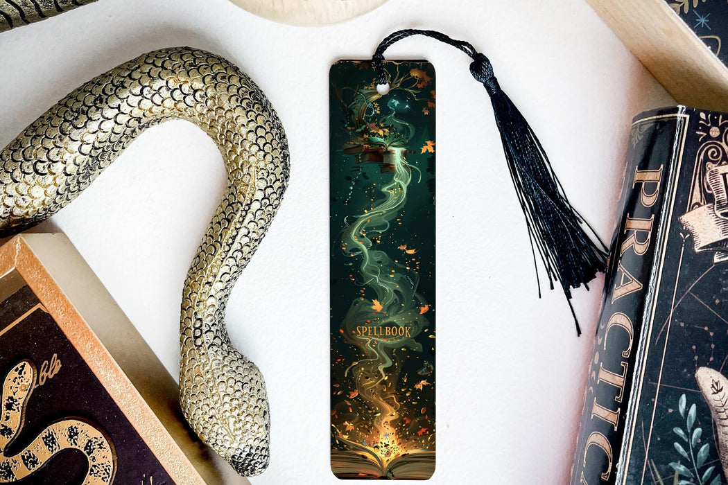 a bookmark with a snake and a book on it