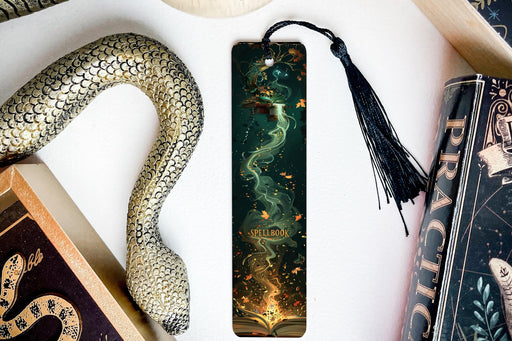 a bookmark with a snake and a book on it