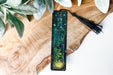 a bookmark with a picture of a forest on it