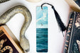 a bookmark with a picture of a sea and a snake on it