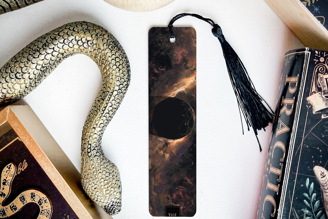 a bookmark, snake, and other items on a table