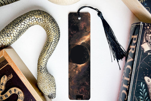 a bookmark, snake, and other items on a table