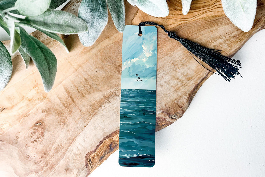 a bookmark with a painting of a boat in the ocean