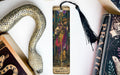 a bookmark with a snake and a book on it