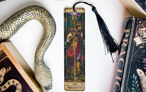 a bookmark with a snake and a book on it
