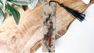 a piece of wood with a tassel hanging from it