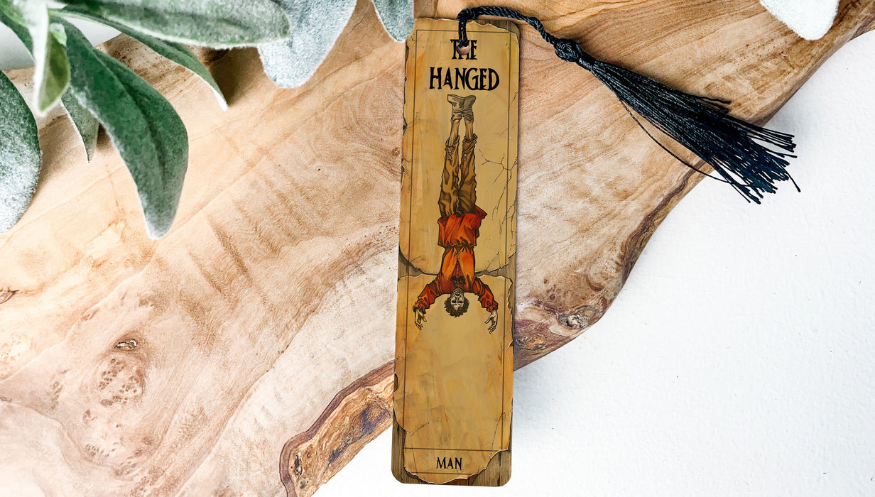 a wooden bookmark with a tassel hanging from it
