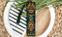 a bookmark with a tassel on top of a plate