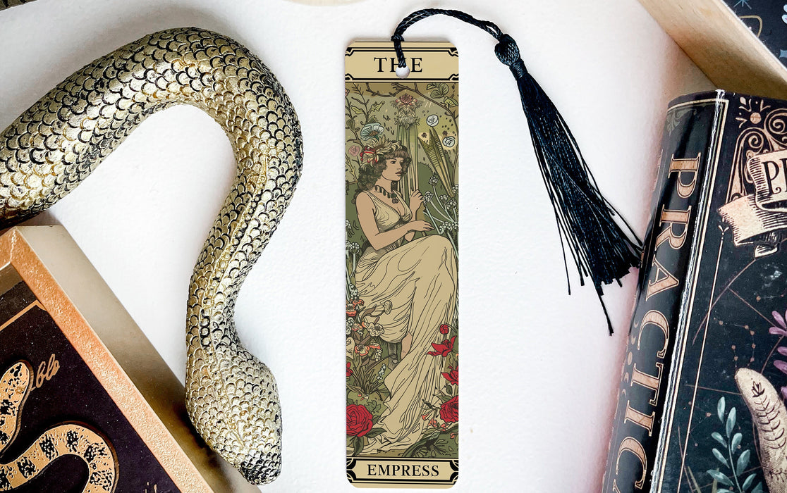 a bookmark with a snake and a book on it