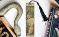 a bookmark with a snake and a book on it