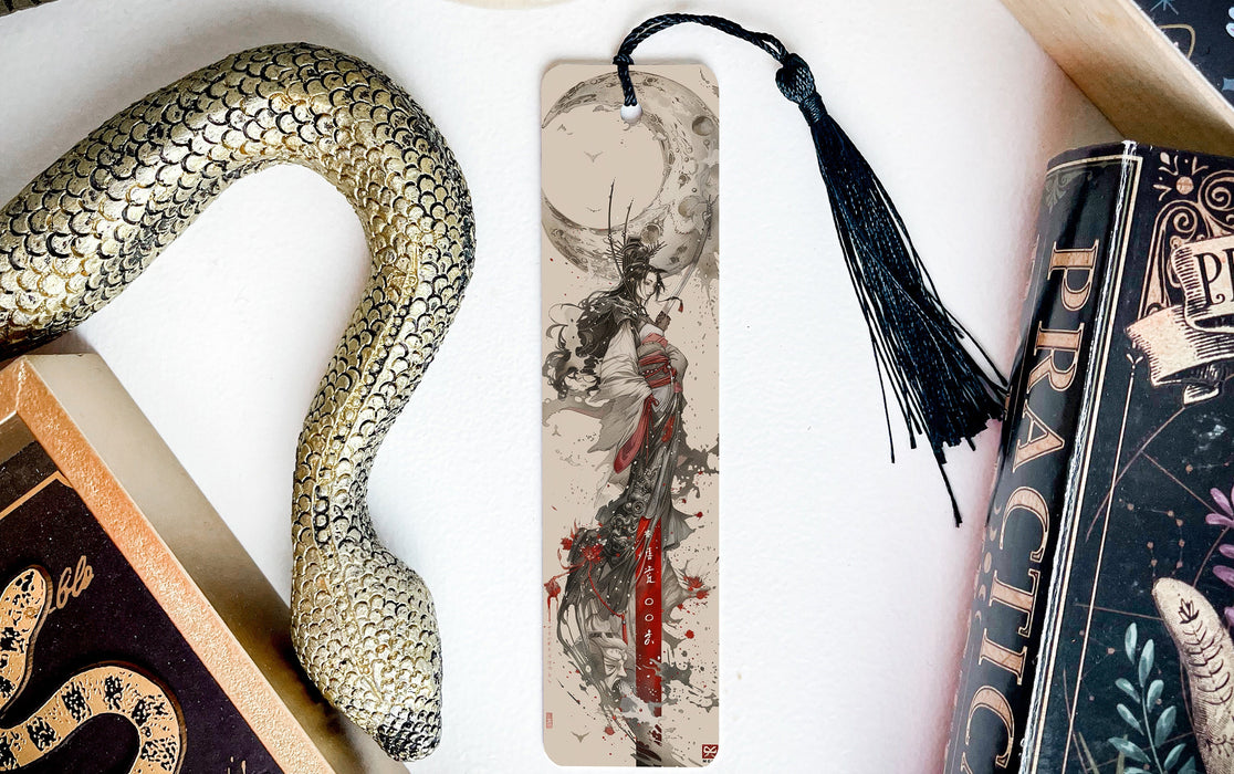 a bookmark with a snake on it next to books