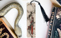 a bookmark with a snake on it next to books