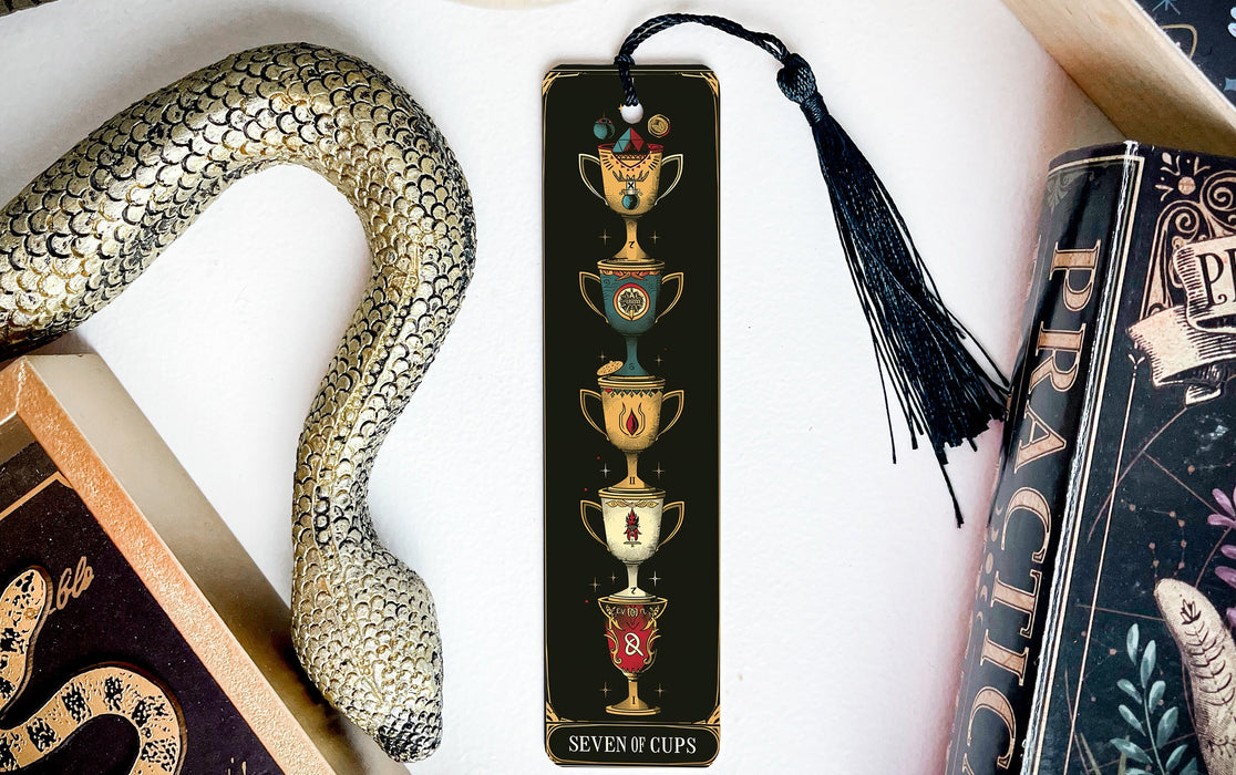 a bookmark with a snake and a cup on it