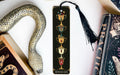 a bookmark with a snake and a cup on it