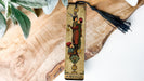 a bookmark with a picture of a man holding a lantern