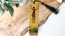 a wooden bookmark with a picture of a person on it