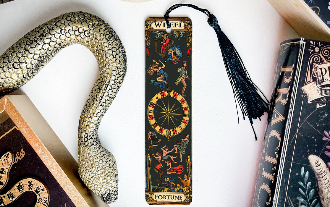 a snake, a bookmark, and some books on a table