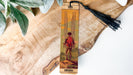 a wooden bookmark with a picture of a boy on it