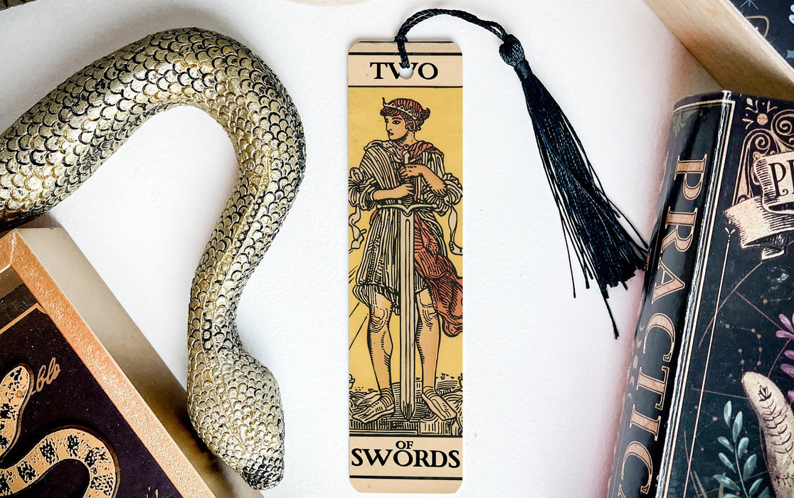 a snake, a tarot, and a tarot card on a table