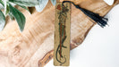 a piece of wood with a tassel hanging from it