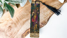 a cross with a tassel hanging from it