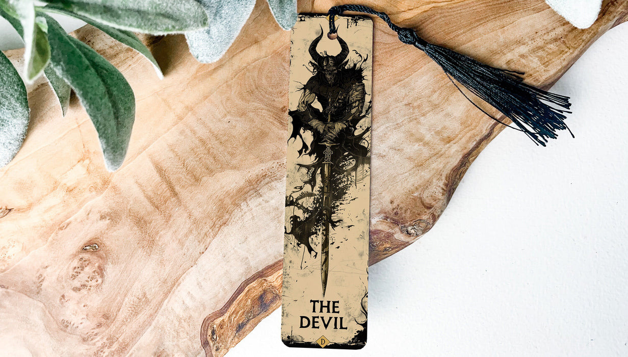a wooden bookmark with a tassel hanging from it