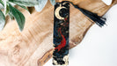 a wooden board with a tassel hanging from it