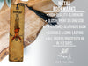 a wooden bookmark with a tassel hanging from it