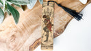 a bookmark with a picture of a woman holding a sword