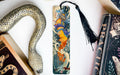 a snake, a bookmark, and some books on a table