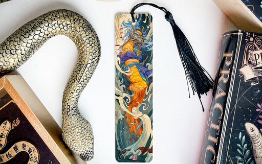 a snake, a bookmark, and some books on a table