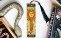 a bookmark with a snake and a sun on it