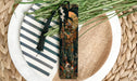 a decorative bookmark on a plate with a plant