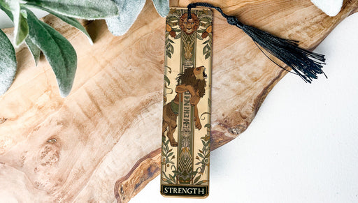a wooden cross with a tassel hanging from it