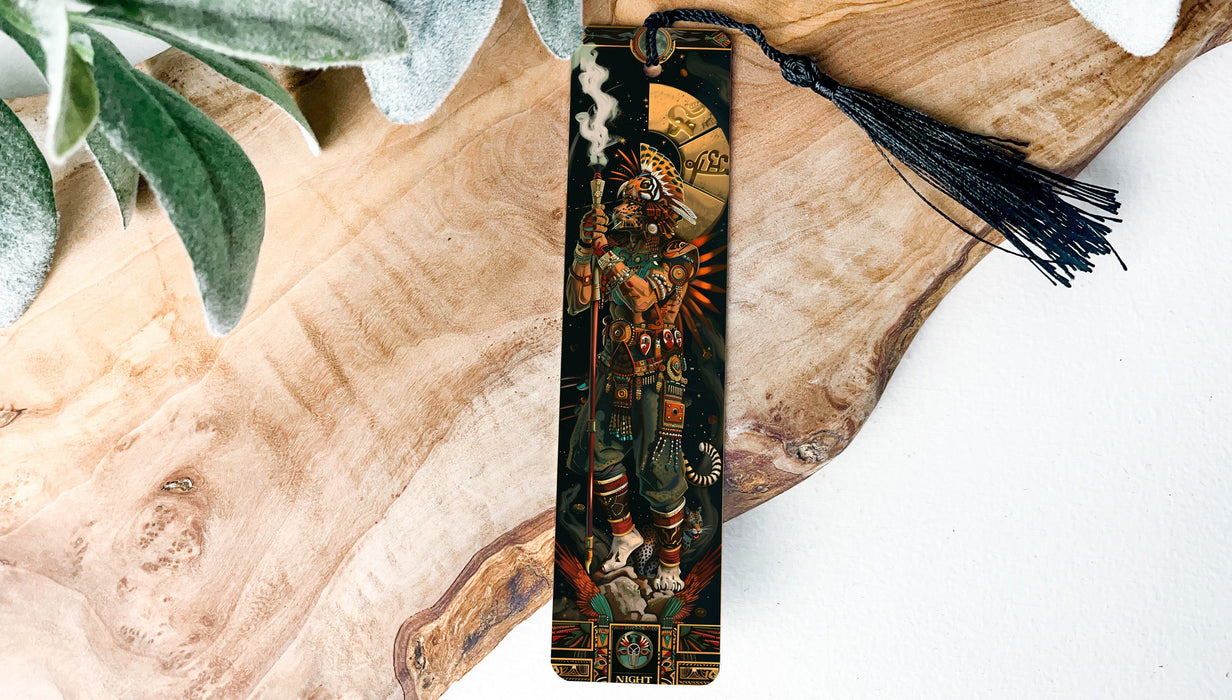 a wooden piece of art with a tassel on top of it