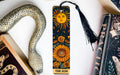 a bookmark with a sun on it next to a snake