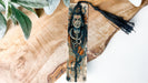 a wooden carving of a man with a hat and tassel