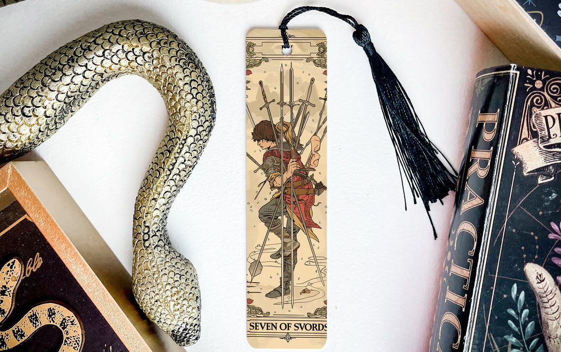 a snake, a bookmark, and some books on a table